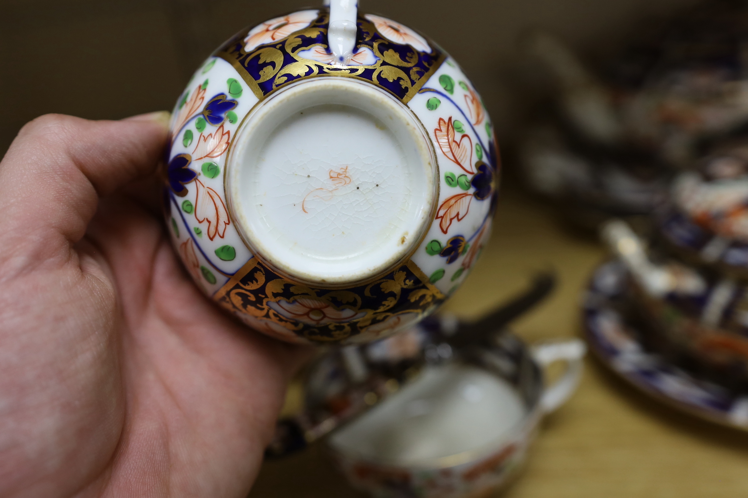 A mid 19th century Derby Imari pattern tea service, comprising a pair of two handled cake plates, a teapot on stand, a sucrier, a cream jug, a bowl and cover, three cups and four saucers, NB: From the Estate of Rt Hon Lo